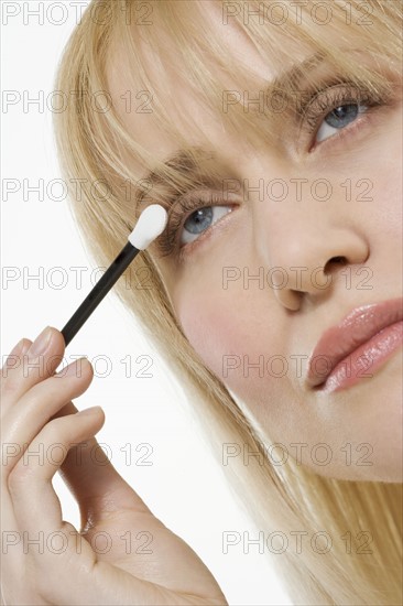 Woman applying eye shadow.