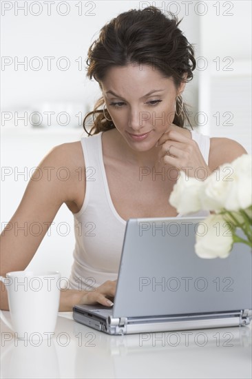 Woman with laptop and coffee cup.