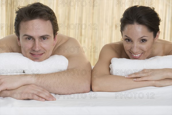 Smiling couple with towels.