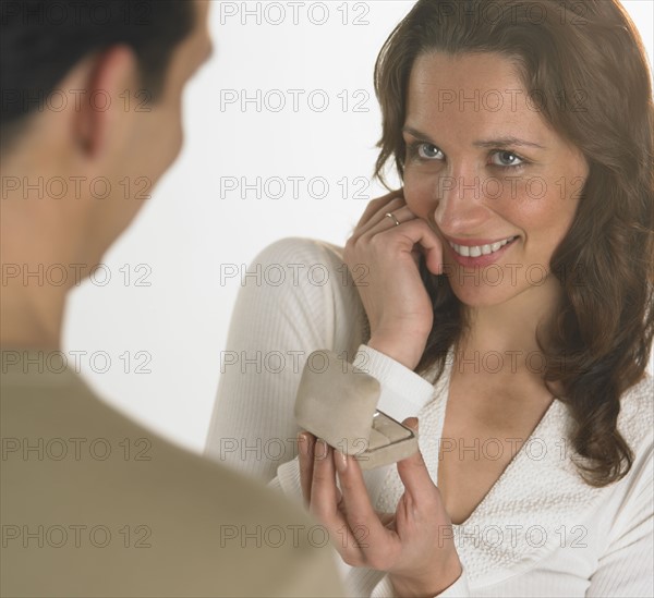 Man giving woman engagement ring.