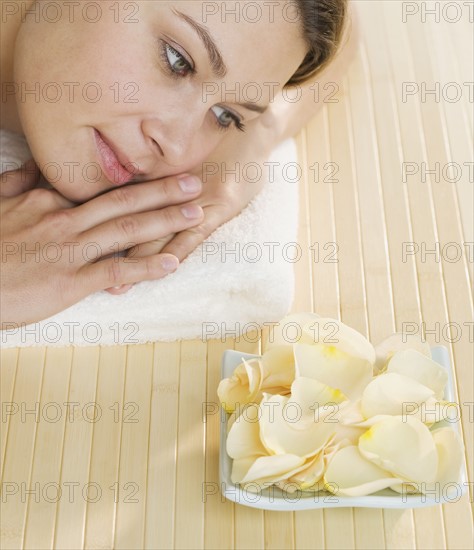 Woman with plate of flower petals.