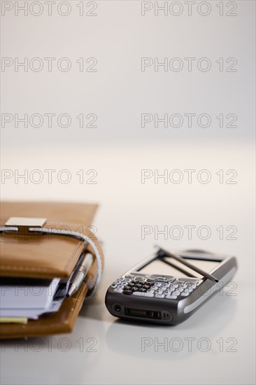 Studio shot of PDA and date planner book.