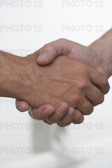 Closeup of men shaking hands.
