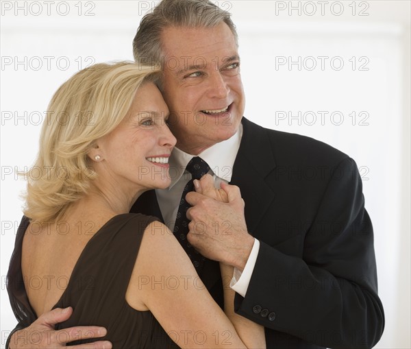 Studio shot of senior couple dancing.