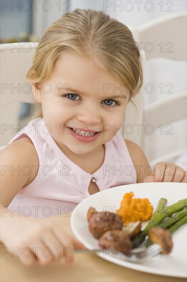 Portrait of girl at dinner table.