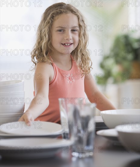 Girl setting table.