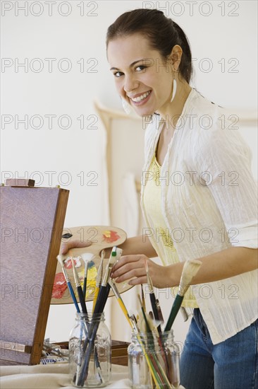 Female artist in painting studio.