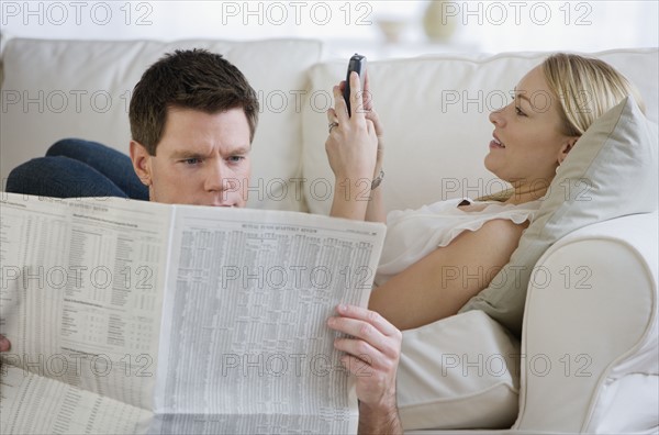 Couple relaxing on sofa.