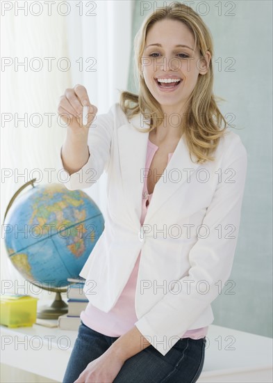 Female teacher pointing with chalk. Date : 2007