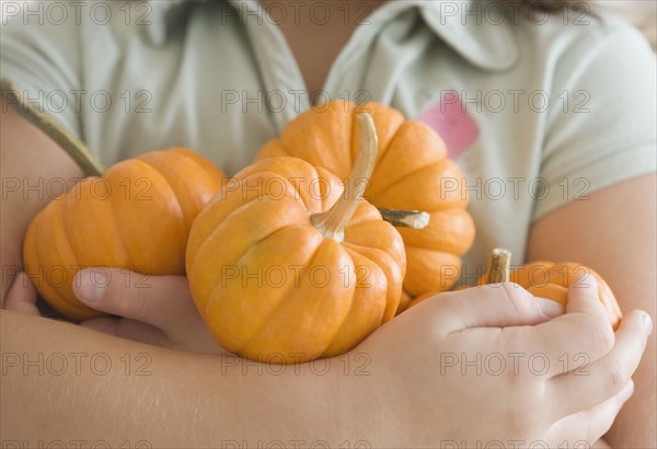 Close up of girl holding pumpkins. Date : 2006