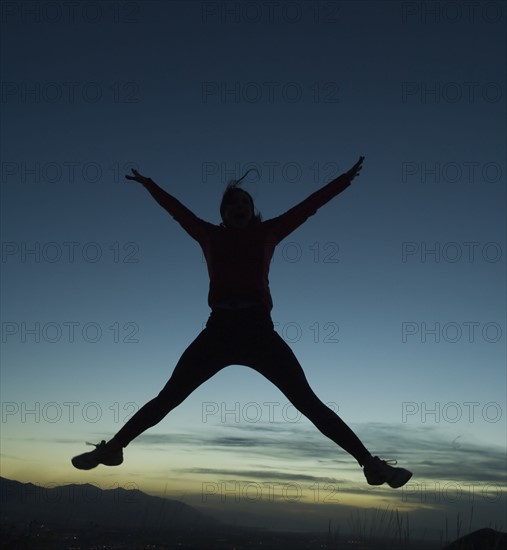 Silhouette of women jumping, Salt Flats, Utah, United States. Date : 2007