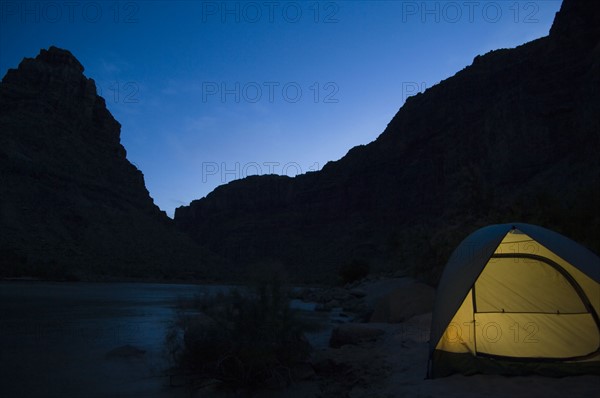 Tent next to river at night, Colorado River, Moab, Utah, United States. Date : 2007