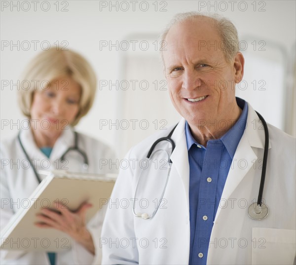 Senior male doctor with stethoscope around neck.