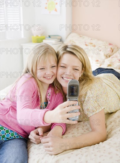 Mother and daughter taking own photograph. Date : 2008