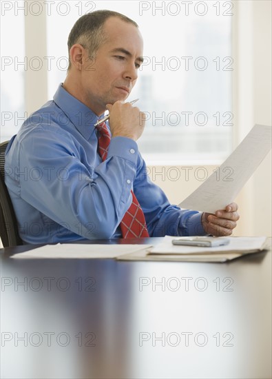 Businessman reading paperwork.