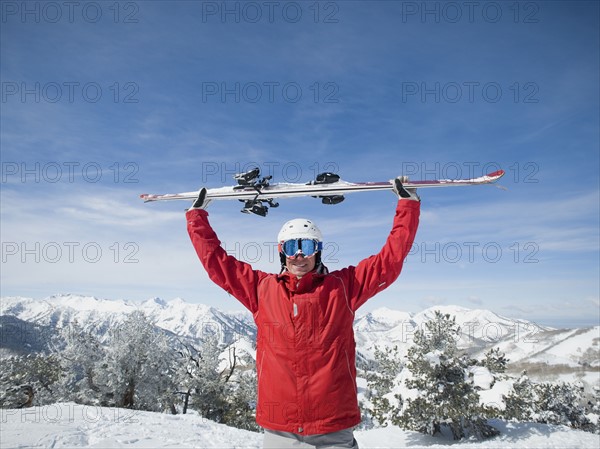 Man holding skis over head. Date : 2008