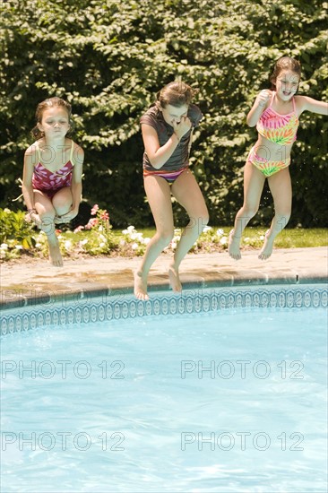 Girls jumping into swimming pool. Date : 2008