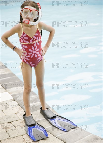 Girl in snorkeling gear standing at edge of swimming pool. Date : 2008