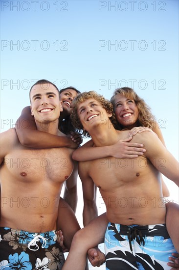 Young men carrying girlfriends on backs. Date : 2008