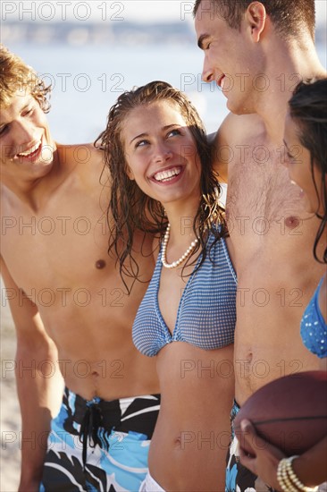 Young couples smiling on beach. Date : 2008