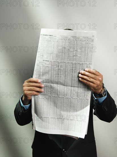 Businessman reading newspaper. Date : 2008