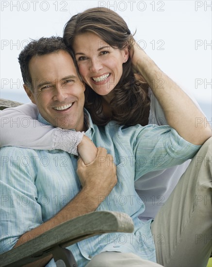 Portrait of couple hugging.