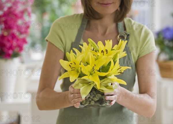 Close up of florist holding flower bouquet.