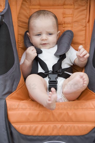 Close up of baby boy in stroller.