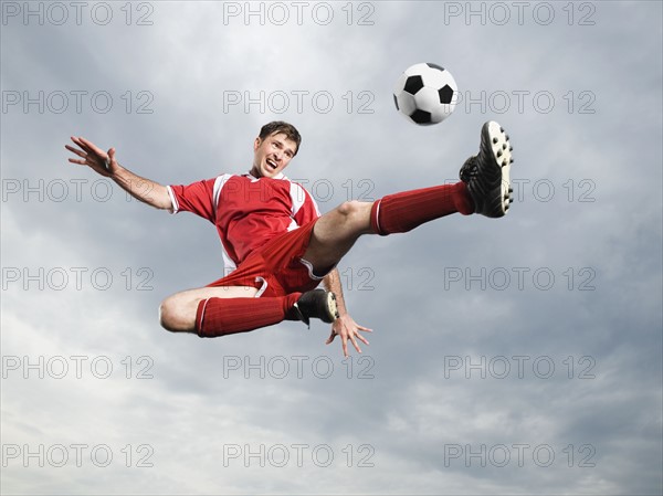 Soccer player kicking soccer ball in mid-air. Date: 2008