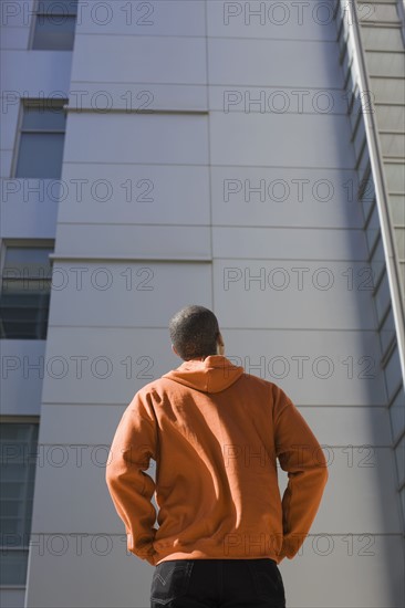 Man looking up at highrise. Date: 2008