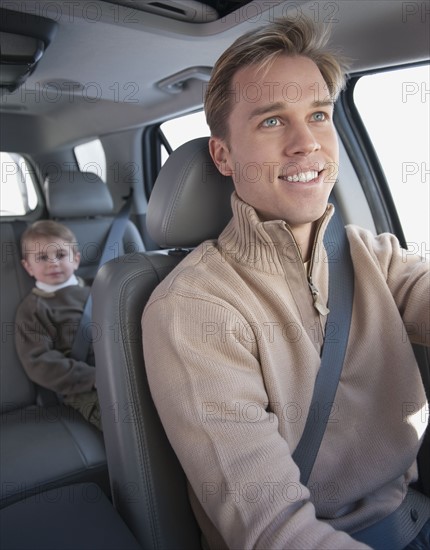 Father driving son to school.