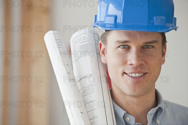 Architect holding blueprints.