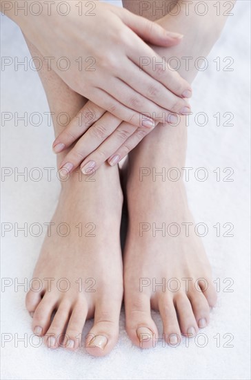 Close-up of woman's hands and feet.