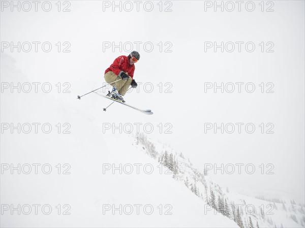 A downhill skier jumping