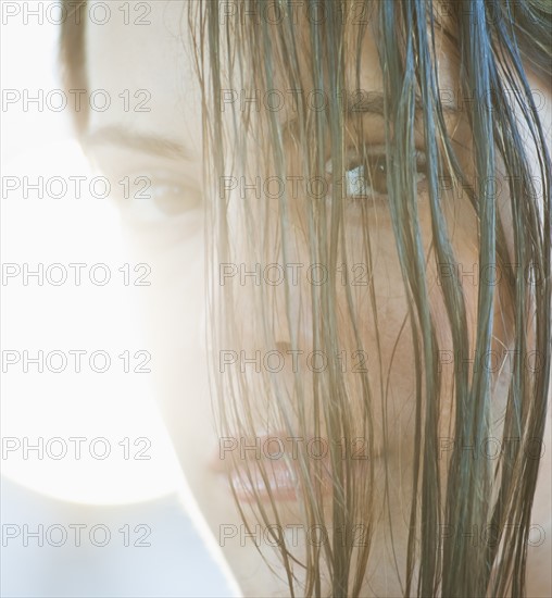 A woman outdoors with hair in her eyes