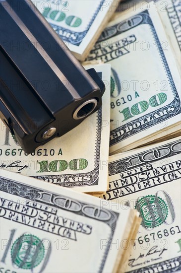 A handgun on stacks of money