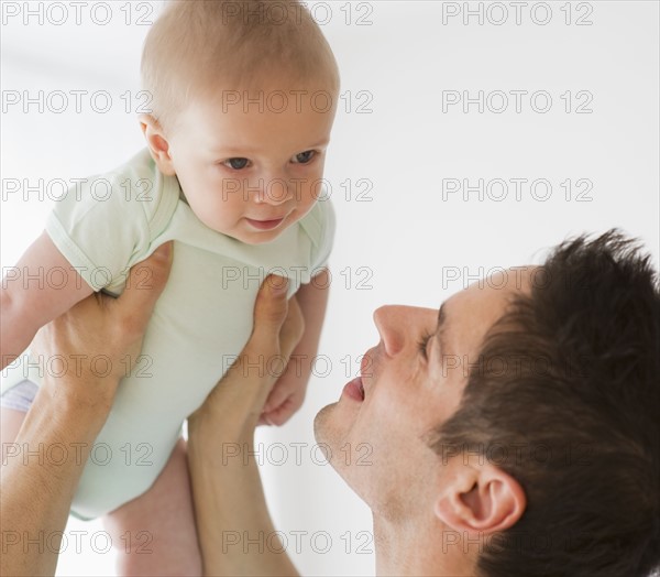 Father holding baby.