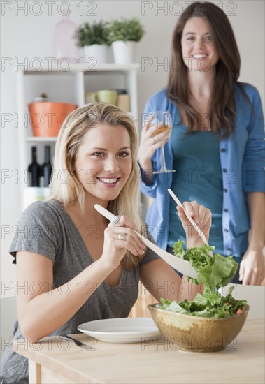 Woman serving salad. Photographer: Jamie Grill