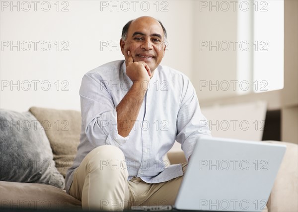 Man working on laptop. Photographer: momentimages