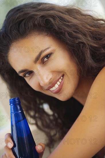 Woman drinking bottled water. Photographer: Rob Lewine