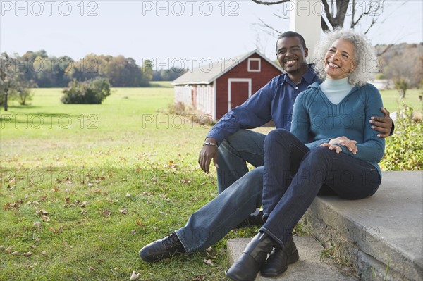 Couple sitting on porch. Photographer: Pauline St.Denis