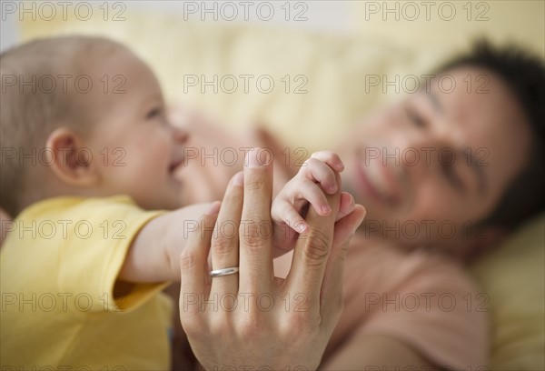 Father and baby playing.