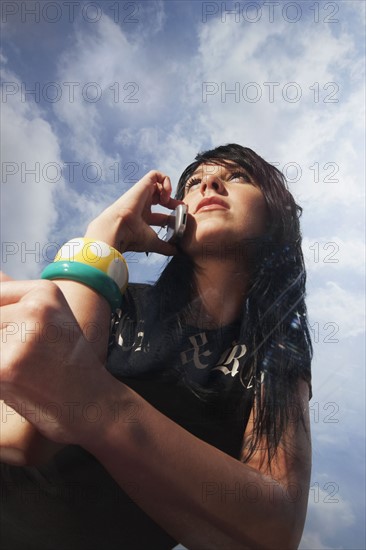 Woman talking on cell phone outdoors. Photo : Stewart Cohen