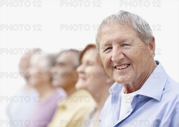 Group of seniors standing in a row. Photo. momentimages