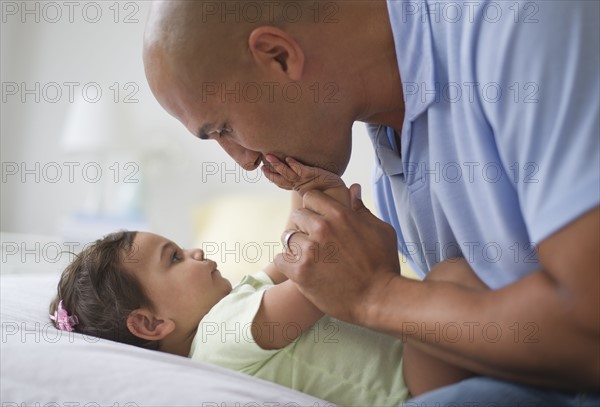 Father with small girl (12-18 months).