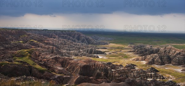 USA, South Dakota, Thick gray clouds over mountains in Badlands National Park.