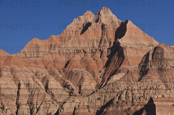 USA, South Dakota, Mountain against blue sky in Badlands National Park.