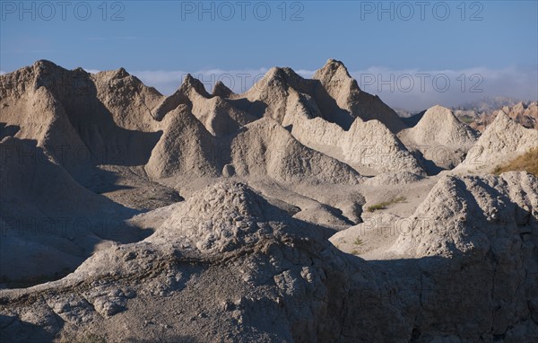 USA, South Dakota, Mountain against blue sky in Badlands National Park.