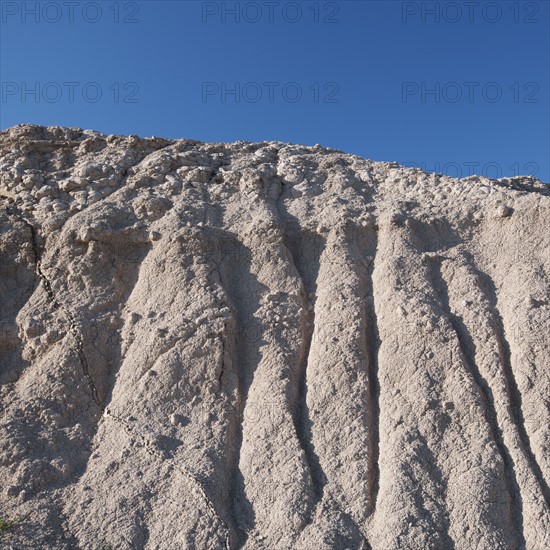 USA, South Dakota, Mountain against blue sky in Badlands National Park.