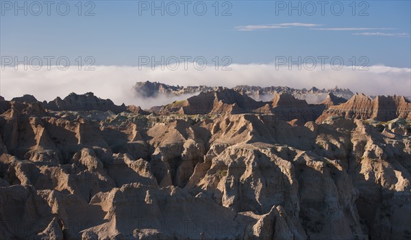 USA, South Dakota, Mountains in morning fog in Badlands National Park.